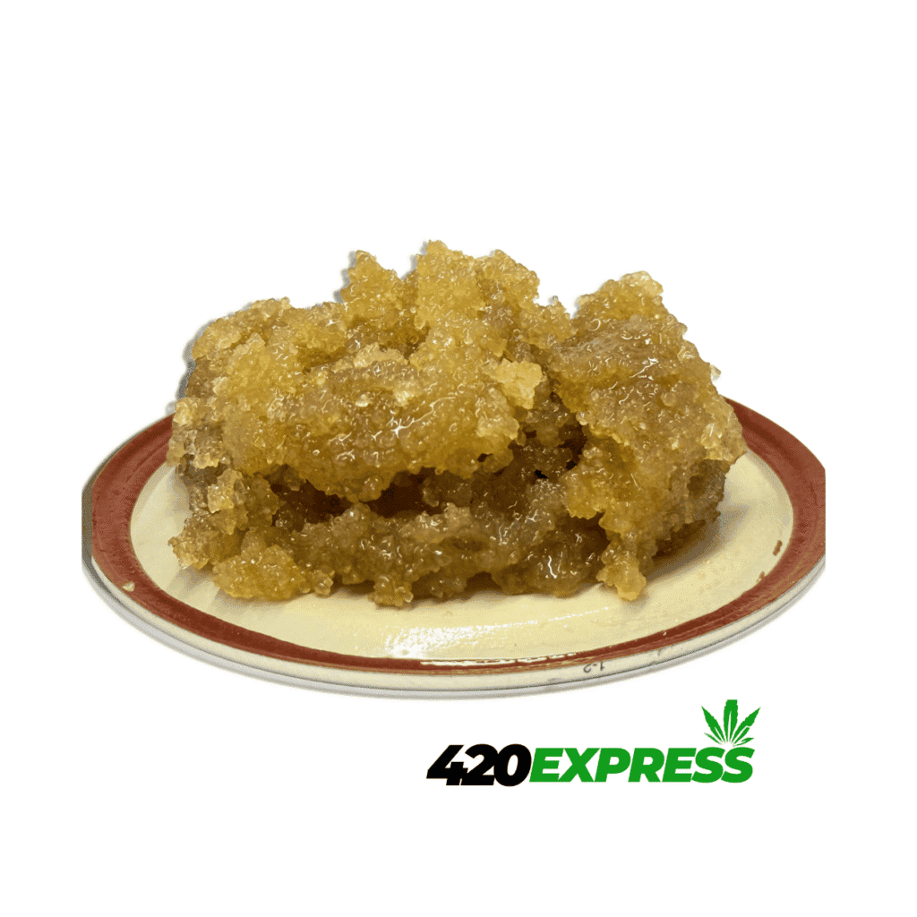 Close-up macro shot of Frozen Grape live resin sugar showing crystalline texture and amber terp sauce
