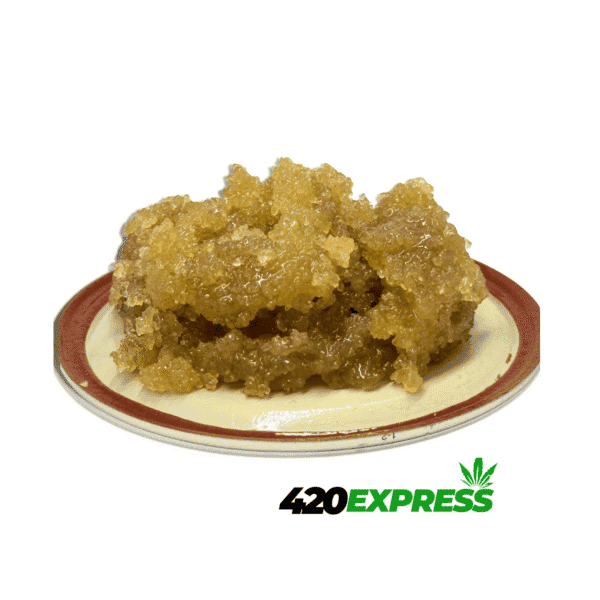 Close-up macro shot of Frozen Grape live resin sugar showing crystalline texture and amber terp sauce